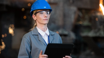 Female engineer with digital tablet in foundry