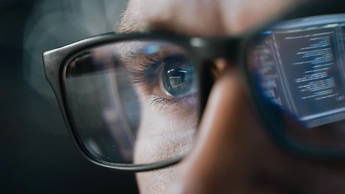 The coding gets reflected on the man's specs