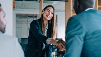 A woman shaking hand with a man