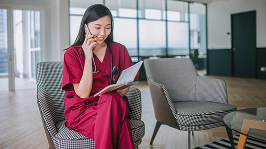 nurse on mobile phone discussing patient chart