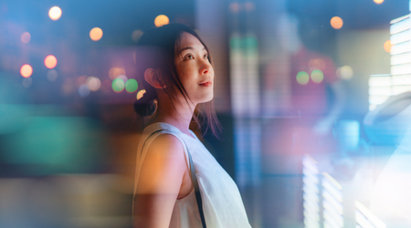 Young woman looking at futuristic digital display