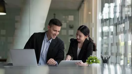 Colleagues reviewing a tablet