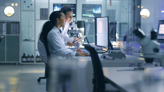 two healthcare professionals reviewing data