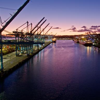 shipping boats at dock with sunset background