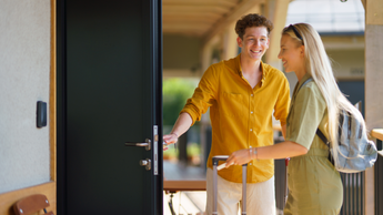 couple checking into hotel room