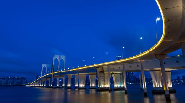 bridge over water with lights on outer edge of bridge