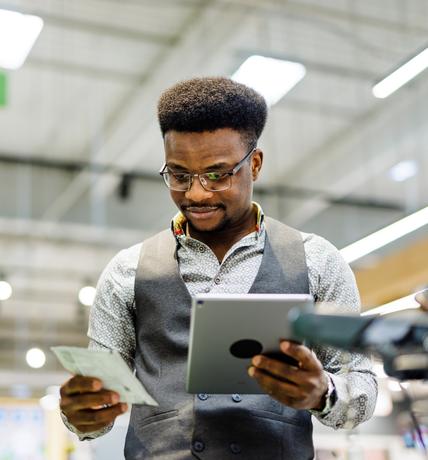 African American man examining products in supermarket