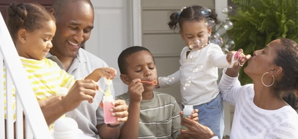 family playing with bubbles