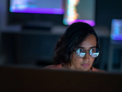 She is using Computer to develop on Advanced Software, Develop Artificial Intelligence Interface