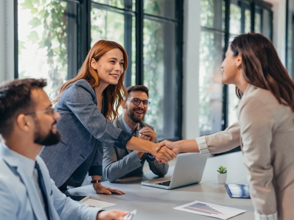 A business meeting where two business woman are shaking hands