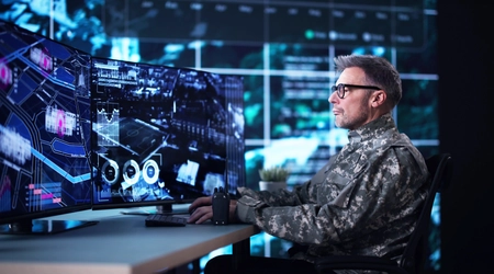 military personnel reviewing computer screens