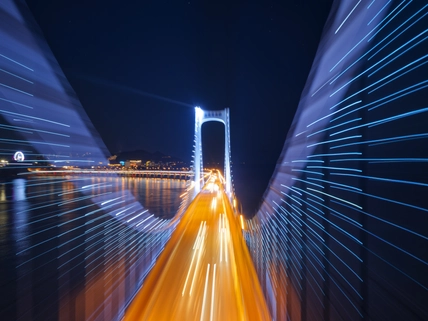 bridge with lights on road below