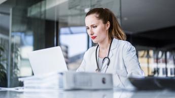 Female doctor using laptop in clinic