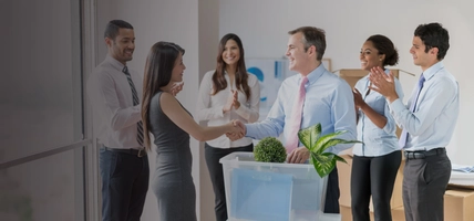 Successful business woman at a new office getting a promotion and boss congratulating her with a handshake