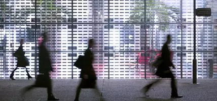 people walking quickly down road