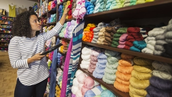 entrepreneur taking inventory in yarn store