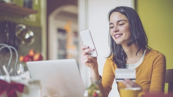 Young woman at home using phone