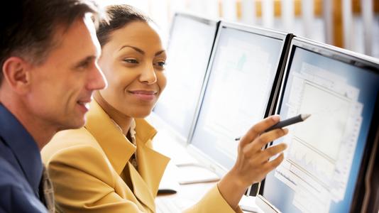 colleagues looking at data on a screen