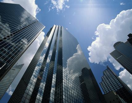 city buildings with bright blue sky and clouds above