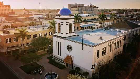 white and blue building in city setting