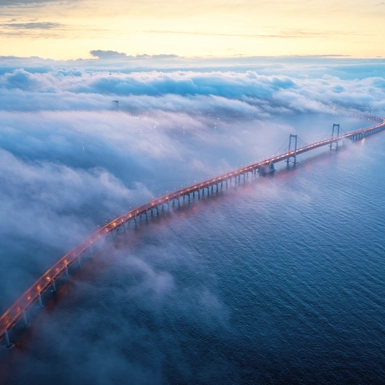 long bridge covered in clouds