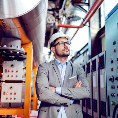 man in hardhat in manufacturing plant