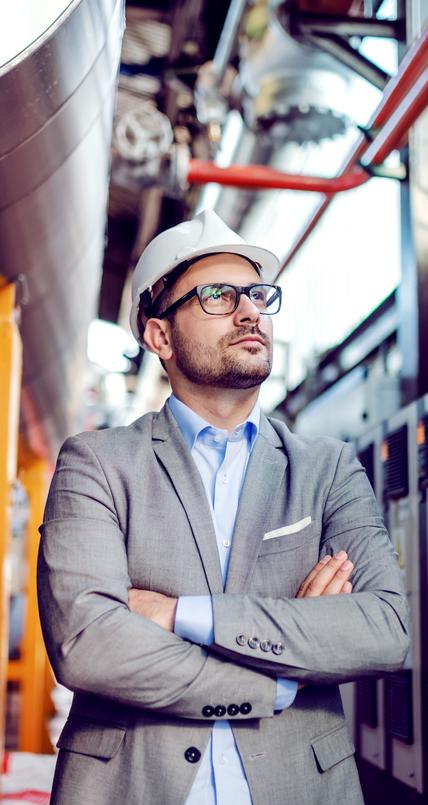 man in hardhat in manufacturing plant