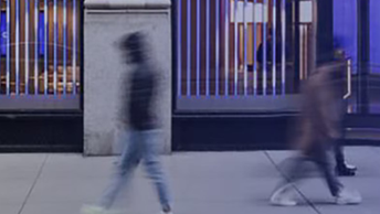 The flow of people passing through the revolving door of the modern office building at the end of the working day