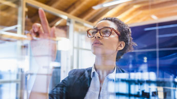 woman working on glass screen