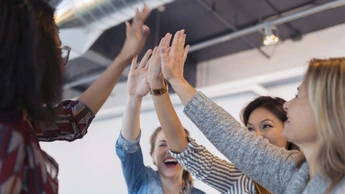 Cheerful women Giving High Five