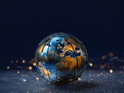 A stylized globe with metallic and reflective surfaces showing continents, set against a dark background with glowing specks.