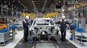 Man is working with his team in manufacturing company 