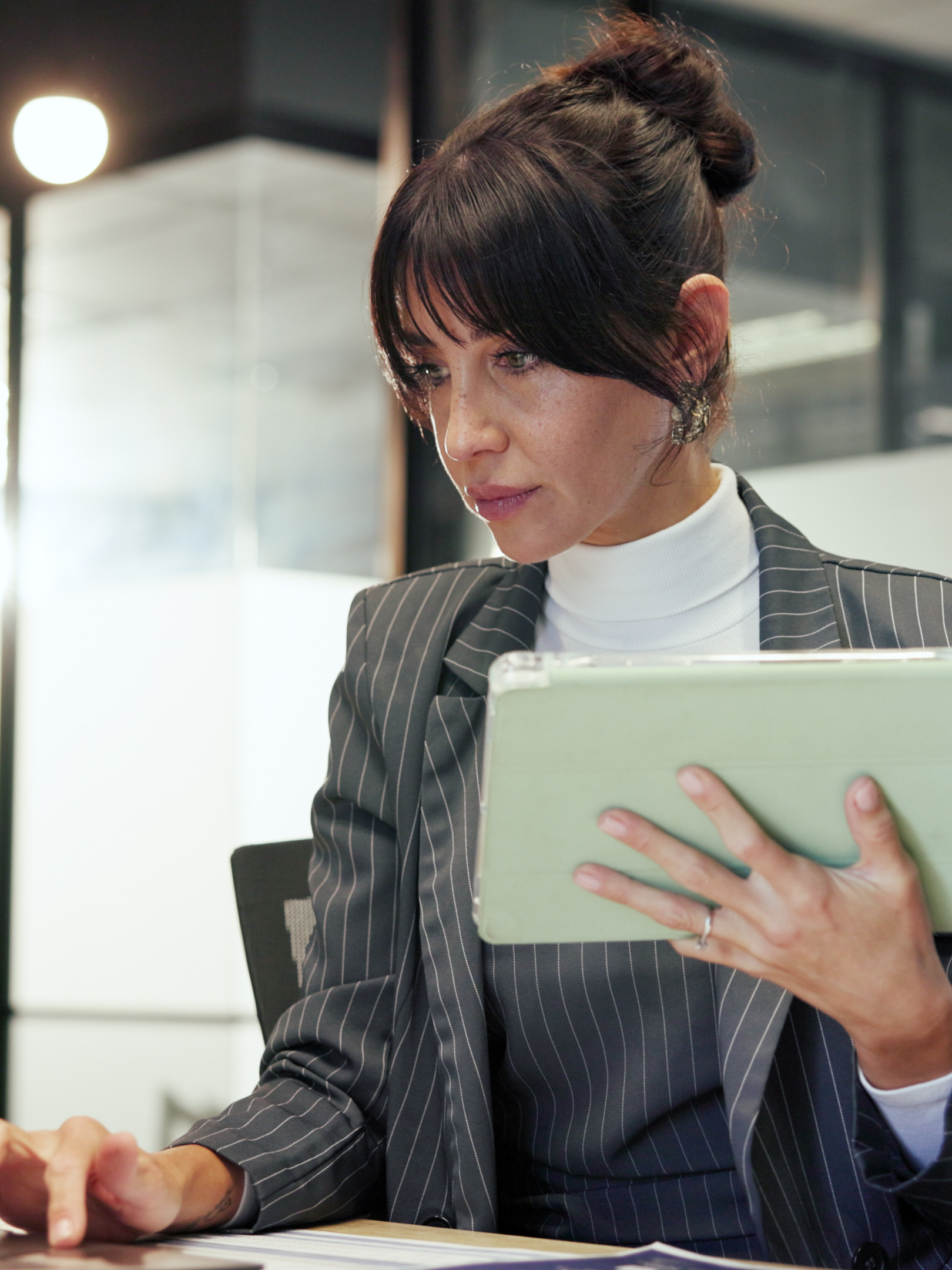 Finance, laptop and tablet with business woman in office for administration or company management. Accounting, app and computer with mature financial manager in corporate workplace for budget review