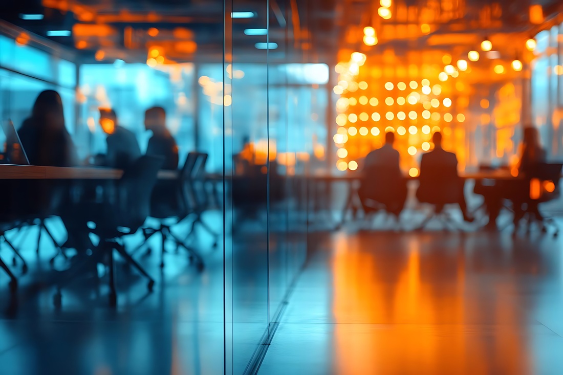 Blurred Photo of Busy Office Meeting Room with Orange and Blue Lighting