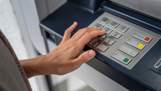 hand using banking machine
