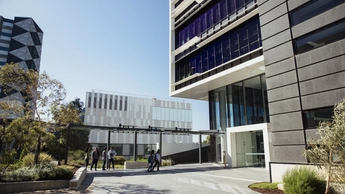 building with people walking in courtyard outside