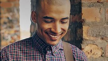 man smiling holding tablet