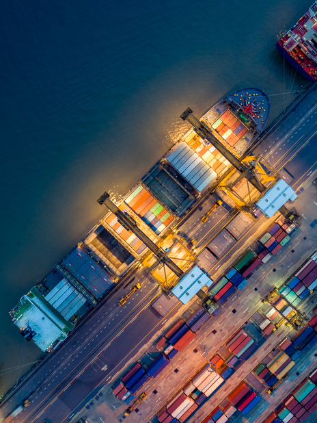 Logistics and transportation of Container Cargo ship and Cargo plane with working crane bridge in shipyard at sunrise, logistic import export and transport industry background