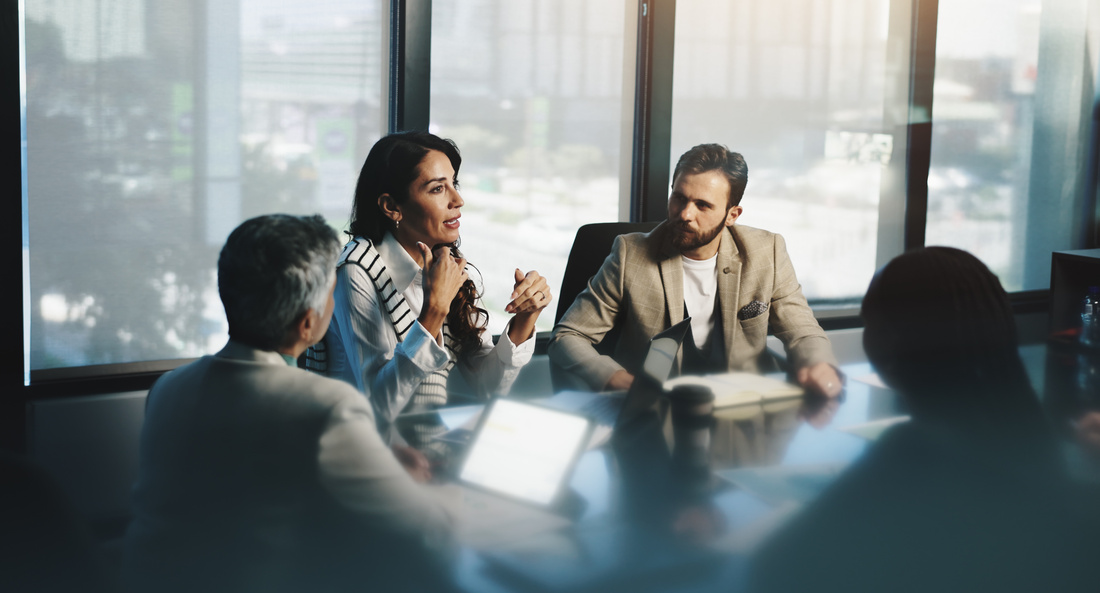 Meeting, woman and collaboration with colleagues, boardroom and discussion for stats, team and company. Corporate, employees and people with info for business, planning and communication for updates