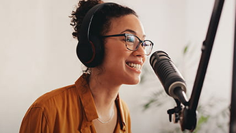 Female podcaster making audio podcast from her home studio