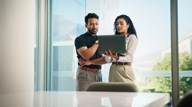two people looking at laptop together