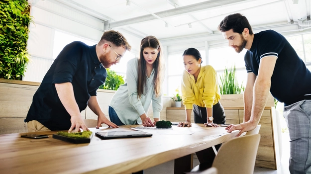 group working around a table review plant material