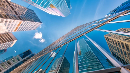 buildings with sky above them and reflections in glass