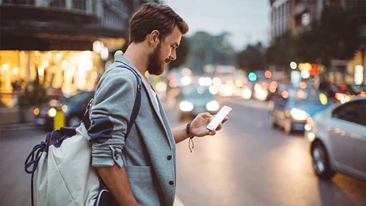 businessman using his smartphone in the city