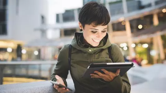 Young handsome caucasian brown straight hair woman using smartphone