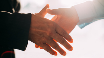 Close-up of male and female hands shaking. Business people greeting with handshake
