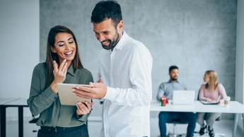 two colleagues looking at tablet together