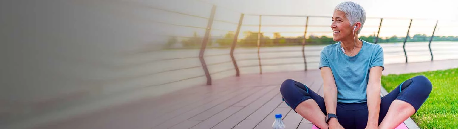 Woman enjoying a Sunset view and listening a music