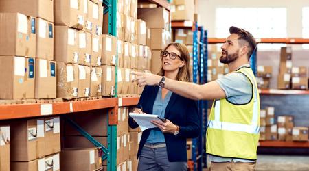 Shot of a young man and woman working together in a warehouse