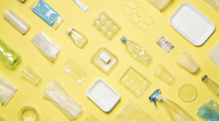 Different types of used plastic packaging arranged on a yellow background